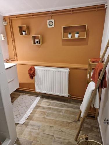 a room with a hallway with a radiator and a floor at Petite maison chaleureuse in Leuze-en-Hainaut
