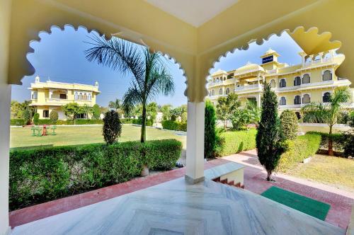 a view of a large house from the courtyard at Padmini Bagh Resort by Inventree, Udaipur in Udaipur
