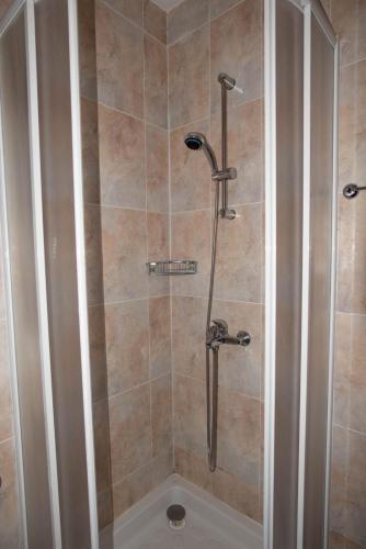 a bathroom with a shower with a toilet in it at ЗАМЪКА 1 in Pamporovo
