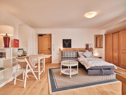 a living room with a couch and a table at Appartement Sunset, 28qm in Schluchsee