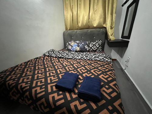 a bedroom with a bed with blue pillows on it at Glory Beach Resort Beach View in Port Dickson