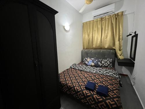 a small bedroom with a bed in a room at Glory Beach Resort Beach View in Port Dickson