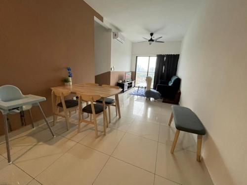 a living room with a wooden table and chairs at Traders Garden , cheras Trader square 3 bedroom Balakong serdang in Cheras