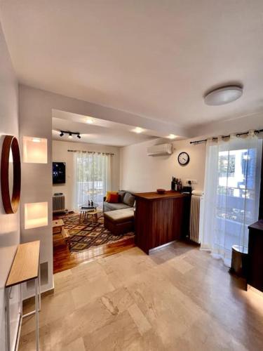 a living room with a couch and a table at Coastal Studio in Palaio Faliro in Palaión Fáliron