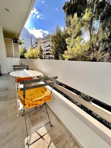 a table and chairs sitting on a balcony at Coastal Studio in Palaio Faliro in Palaión Fáliron