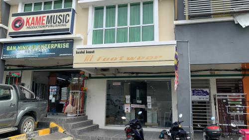 a building with motorcycles parked in front of a store at Harris Homestay Gerik Town, Free Wifi & Netflix in Gerik