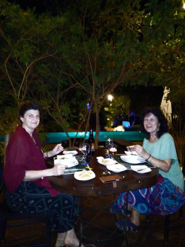 two women sitting at a table with plates of food at Vimanra Udawalawa in Udawalawe