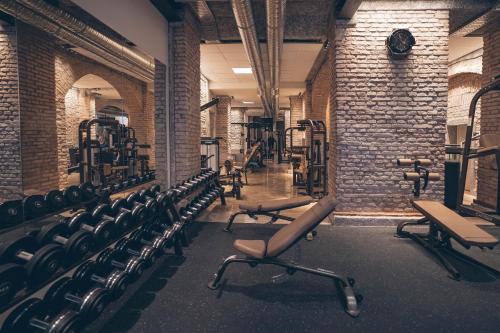 a gym with rows of chairs and a brick wall at Living Hotel Das Viktualienmarkt in Munich