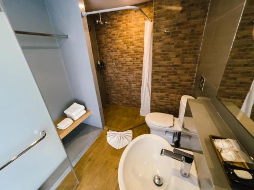 a bathroom with a sink and a toilet at Nest by Sangob in Bangkok