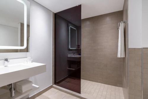 a bathroom with a sink and a shower at Park Inn by Radisson Polokwane in Polokwane