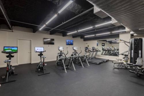 a gym with several treadmills and exercise bikes at Tasteful Condo Walking Distance to French Quarter in New Orleans
