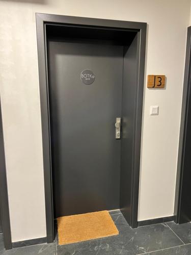 a elevator door in a building with a yellow rug at BOTKa apartmán, Tatranská Štrba in Tatranska Strba