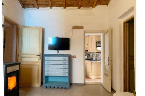 a kitchen with a dresser with a television on top of it at Casa Magar Pula in Pula