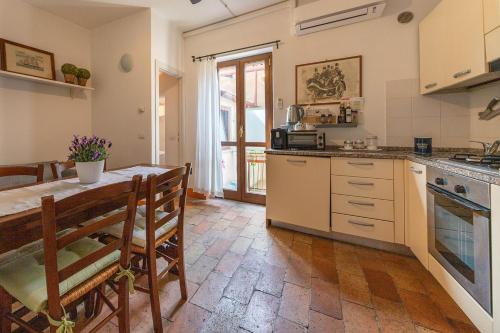 a kitchen with a table and a dining room at Case di Anna in Assisi