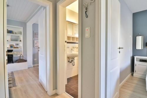 a bathroom with a sink and a toilet in a room at Langeooger Viermaster - Blaues Segel in Langeoog