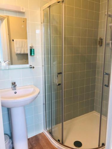 a bathroom with a sink and a shower at Varley House in Ilfracombe