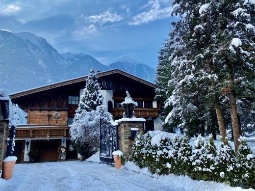a house with a gate in the snow at Villa22 Oetz in Oetz