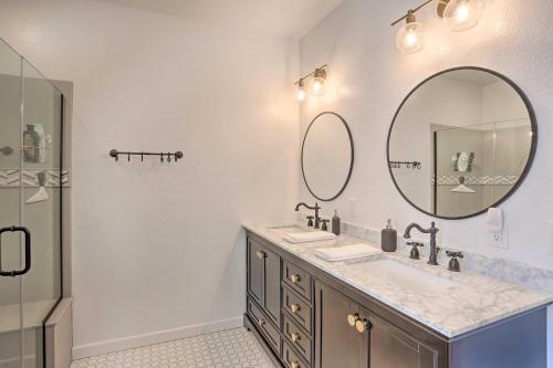 a bathroom with two sinks and a mirror at Home Near Downtown and Spearfish Canyon! in Spearfish
