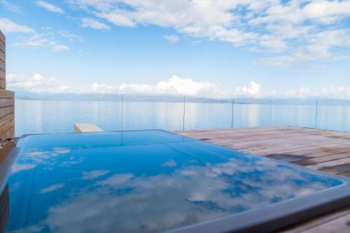 a swimming pool with a view of the water at Alissachni SeaSide Hotel in Derveni