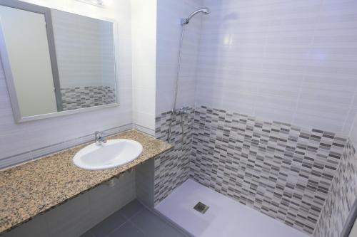 a bathroom with a sink and a mirror at Golf D 201 ONLY FAMILIES in Cambrils