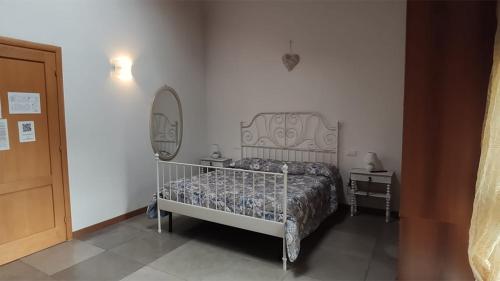 a bedroom with a bed with a mirror and a bed frame at Mulino Delle Valli in Cerea