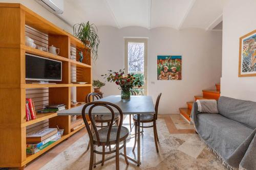 a living room with a table and chairs and a couch at Case di Anna in Assisi