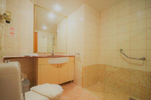 a bathroom with a shower and a sink and a toilet at Select Suite & Apart Hotel in Alanya