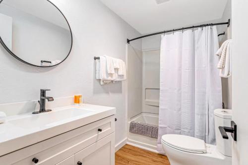 a white bathroom with a sink and a mirror at Tidal House 6 in Ocean Shores