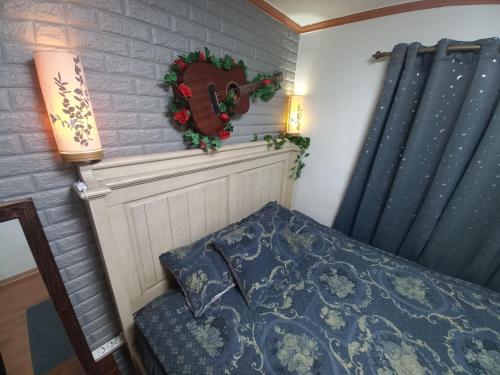 a bedroom with a bed and a wreath on the wall at Newly renovated hidden gem #2 in Seoul