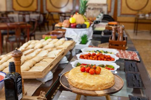 a table topped with lots of different types of food at Hotel Macià Alfaros in Córdoba