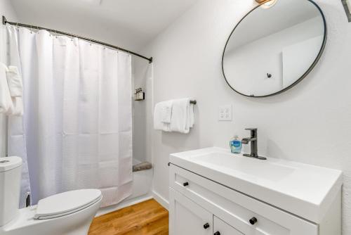 a white bathroom with a sink and a mirror at Tidal House 7 in Ocean Shores