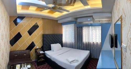 a bedroom with a bed and a ceiling fan at Hotel Heaven Inn in Dhaka