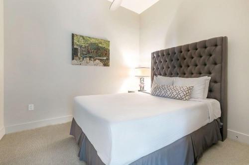 a bedroom with a large bed with a large headboard at Captivating Condo near City Hot Spots in New Orleans