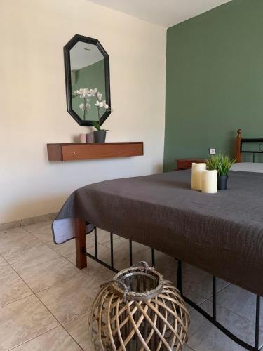 a bedroom with a bed with a mirror on the wall at Dionysus Sivota Center in Syvota