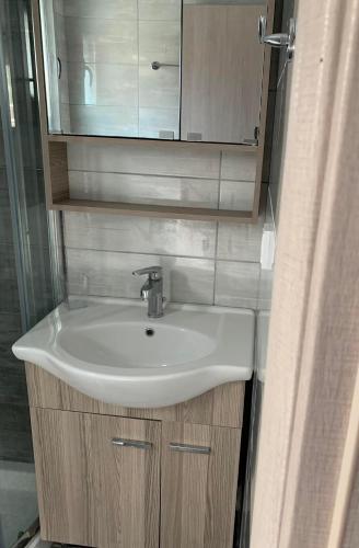 a bathroom with a sink and a mirror at Dionysus Sivota Center in Syvota