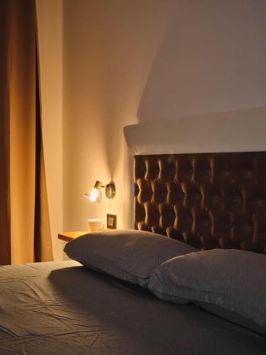 a bedroom with a bed with a headboard and a table at VILLA MARGHERITA in Pieve di Soligo