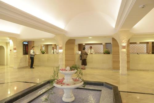 a lobby with a toilet in the middle of a building at Monarque Dar Jerba Narjess in Taguermess