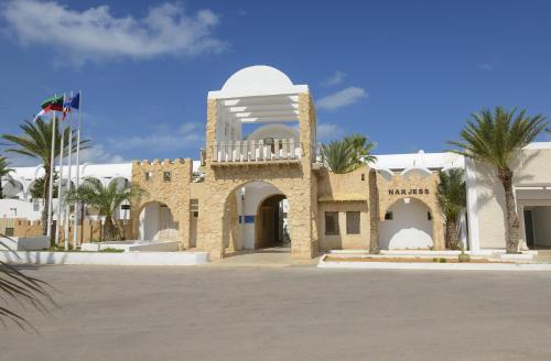 a building with a balcony on top of it at Monarque Dar Jerba Narjess in Taguermess