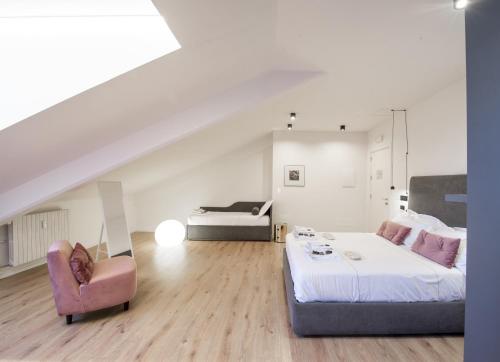 a bedroom with a bed and a couch and a chair at San Carlo Suite Torino in Turin