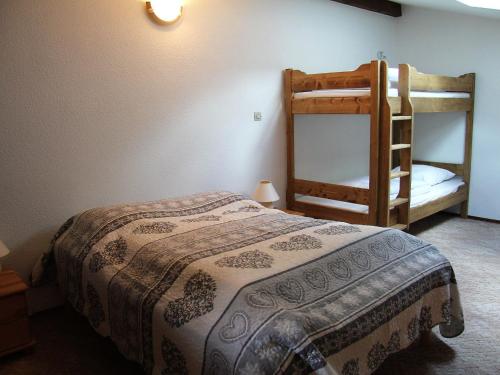a bedroom with a bed and a bunk bed at Appartement La Clusaz, 3 pièces, 6 personnes - FR-1-459-147 in La Clusaz