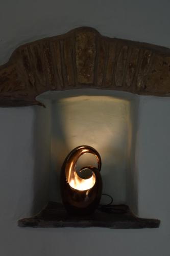 a light on a shelf with a candle in it at Crug Glas Country House in St. Davids
