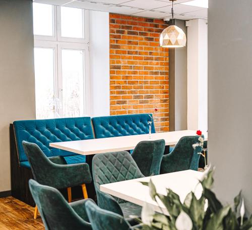 a room with tables and chairs and a brick wall at Hotel Stronie in Stronie Śląskie