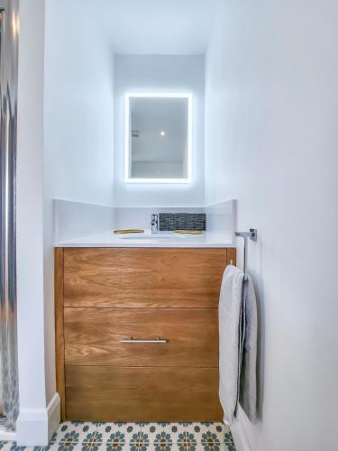 a bathroom with a wooden drawer and a sink at The Kinsale 4 Center in Kinsale