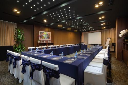 a conference room with a long table with blue and white chairs at Authentic Hanoi Boutique Hotel in Hanoi