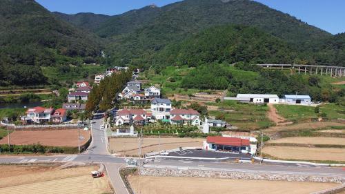 an aerial view of a town on a mountain at Ever Rose Pension in Namhae