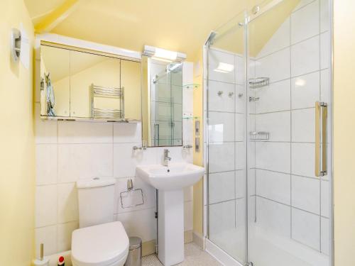 a bathroom with a shower and a sink and a toilet at Oak Cottage in Saxmundham