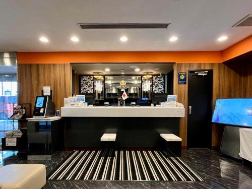 a lobby of a hotel with a reception desk at APA Hotel Hamamatsu Eki Minami in Hamamatsu
