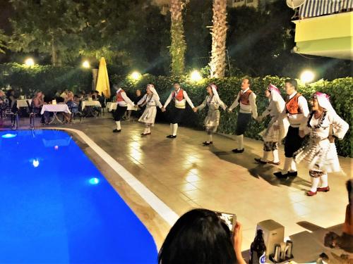 a group of people performing a dance by a pool at Select Suite & Apart Hotel in Alanya
