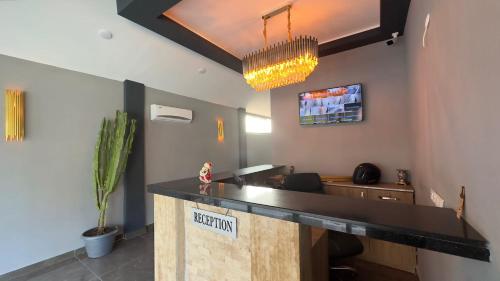 a lobby with a reception desk with a potted plant at Alanya Central Apartments in Alanya