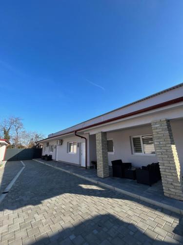 a house with a driveway in front of it at ALFA Apartmani in Subotica